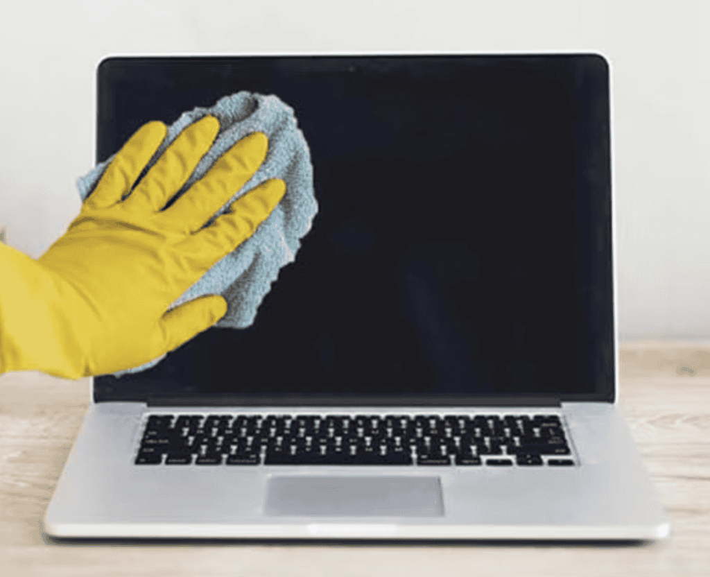 Cleaning MacBook screen with microfibre cloth
